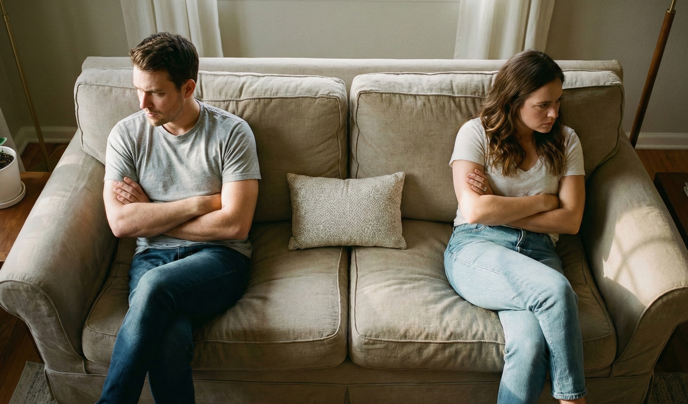 Couple drifting apart on a couch